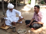 Our guide Manu shares opium tea with Bishnoi elder