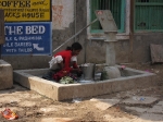 Girl washing at water well